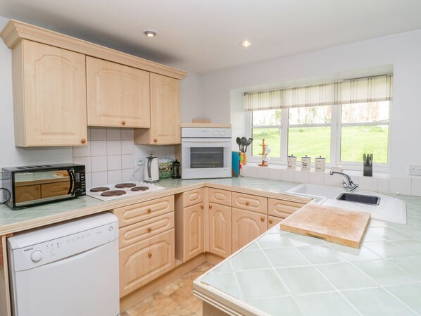 Enjoy cooking in this well-equipped kitchen with an oven, microwave, and dishwasher.