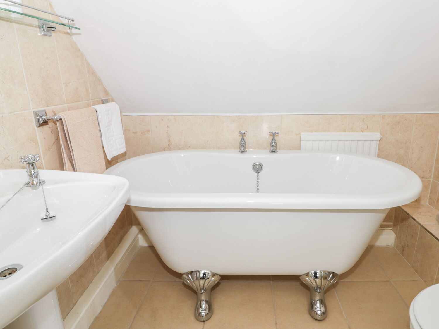 A bathroom with a freestanding bathtub, a sink, and a toilet.