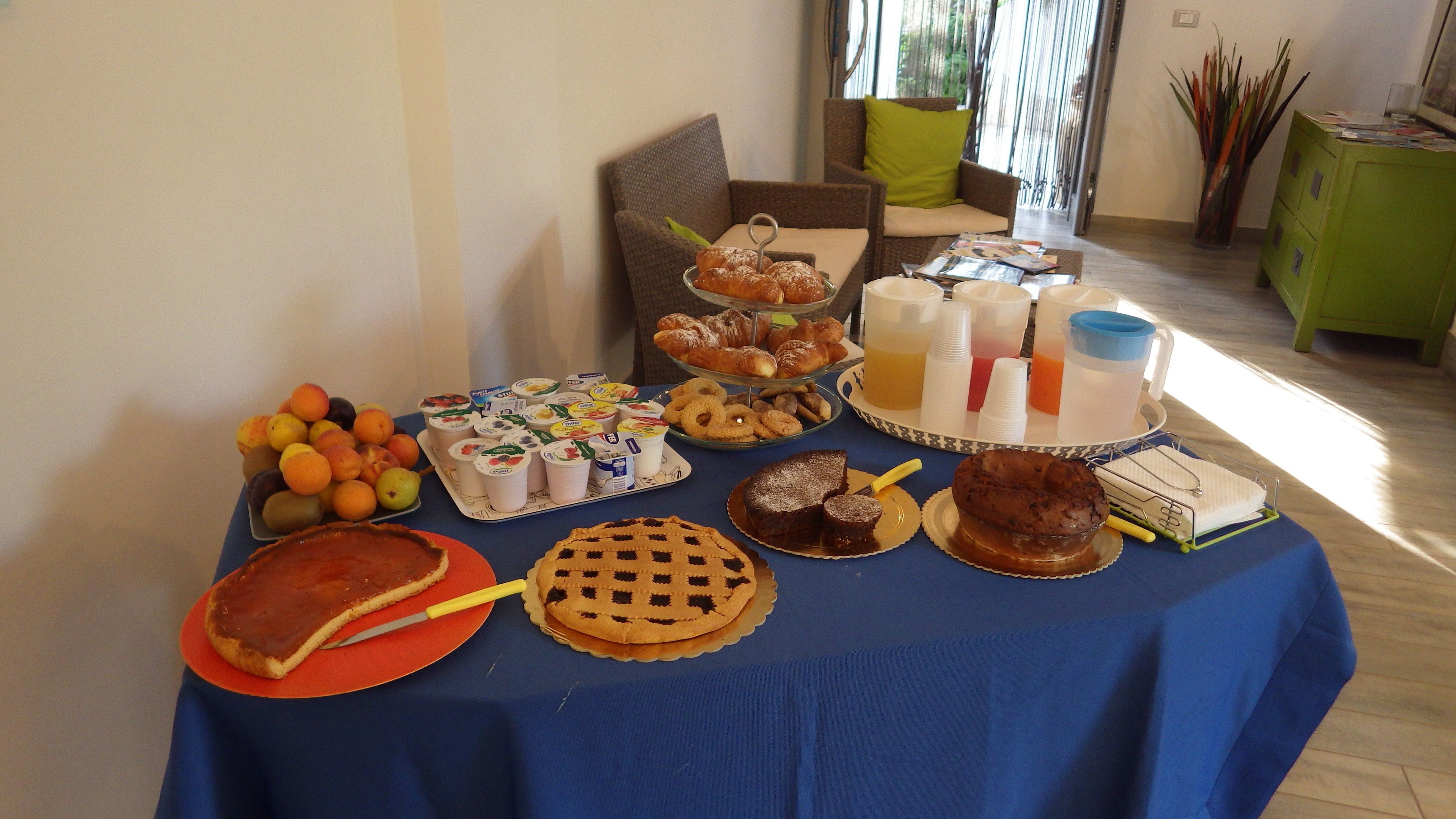 A buffet table with various food items and drinks.