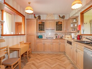 Enjoy cooking in this well-equipped kitchen with a dining table and modern appliances.