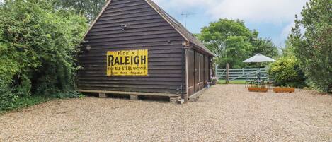 A wooden building with a sign advertising Raleigh bicycles.