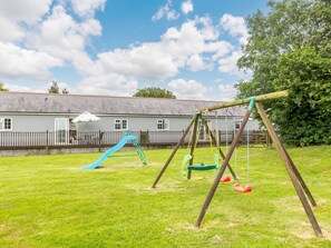 Guests can enjoy a fun outdoor play area with a slide and swings.