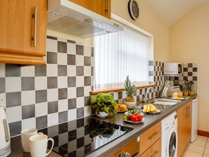Enjoy cooking in this well-equipped kitchen with an oven, microwave, and toaster.