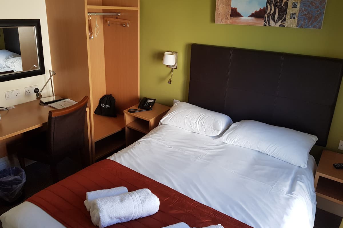 Select Comfort beds, desk, laptop workspace, iron/ironing board