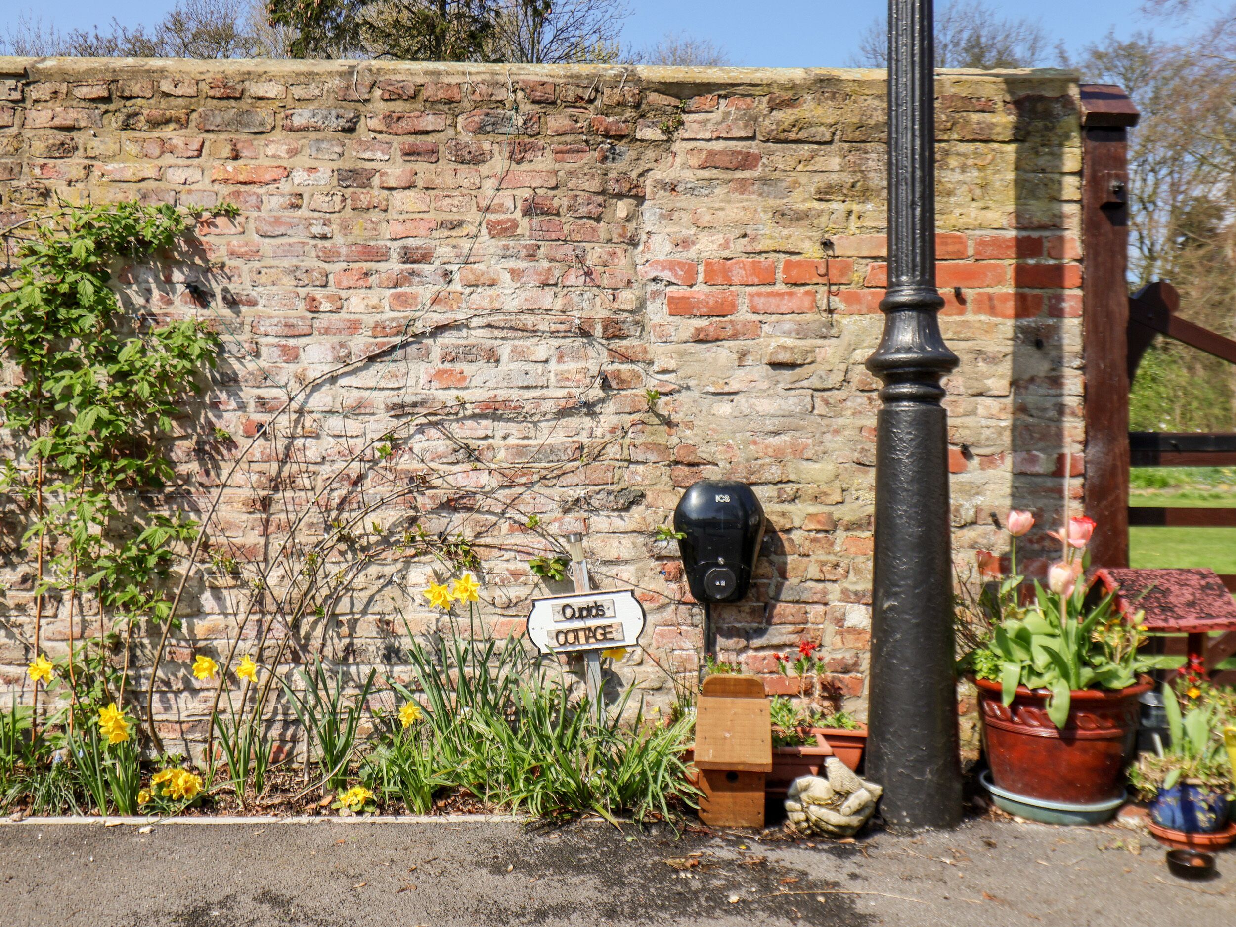A brick wall with a sign reading "Cottage."