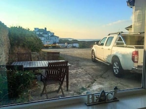 Guests can enjoy a patio area with a table and chairs, offering a scenic view of the surrounding landscape.