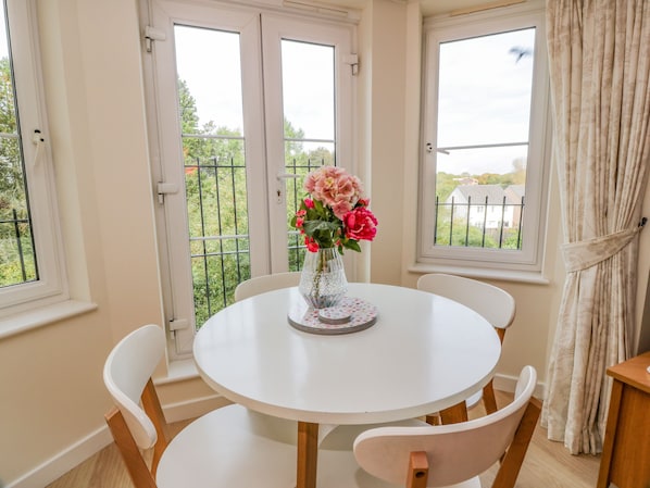 Enjoy meals with family and friends at the round dining table for four.