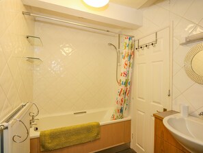 A bathroom with a bathtub, a shower, a toilet, and a sink.