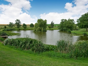 Surrounded by lush greenery and mature trees, this serene setting offers a peaceful spot for relaxation.