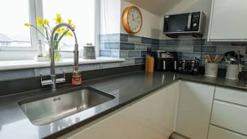 Cottage | Private kitchen | Stovetop, dishwasher, highchair, cookware/dishes/utensils