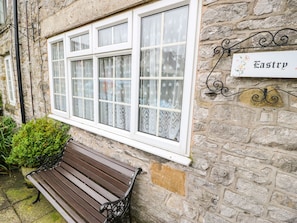 Experience the charm of Fastry, a traditional building with a cozy seating area and inviting windows.