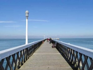 Stroll along the pier and enjoy the serene views of the calm water.