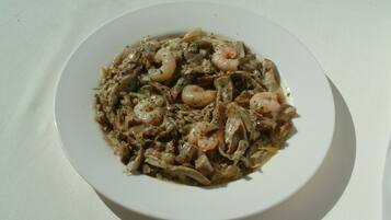 A plate of food with shrimp and vegetables on a white plate.