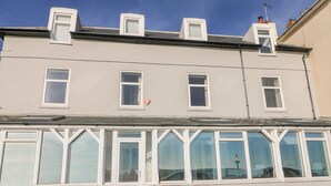 A two-story building with multiple windows, a visible door, and a sign indicating 'SOUTHCOURT'. - The Eaves (Folkestone)