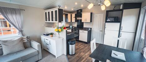 A compact kitchenette with a stove, oven, and refrigerator.