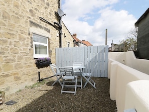 Enjoy a peaceful seating area with a table and chairs, complemented by a sofa and a window with a view.