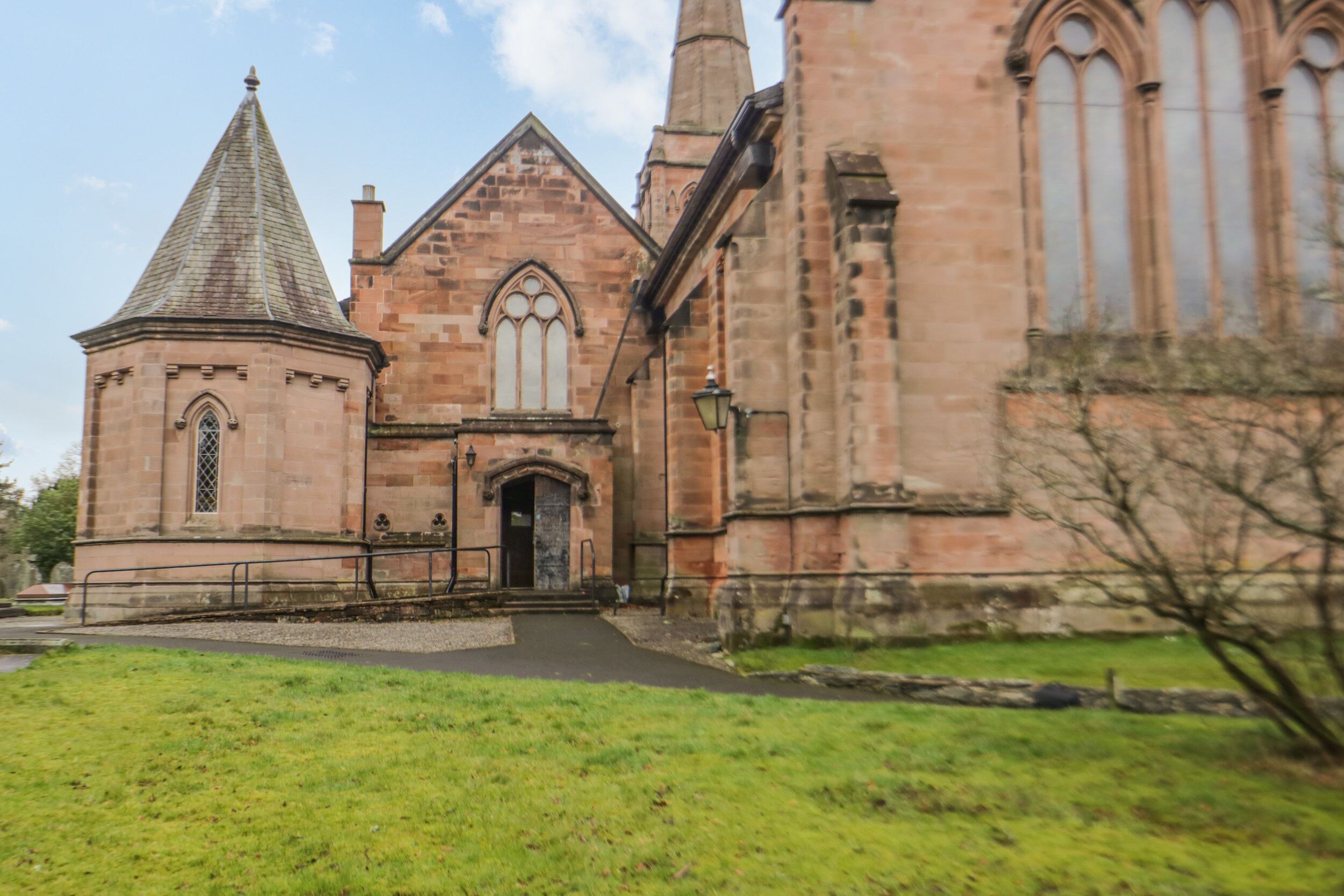 A church with a prominent tower and arched windows.