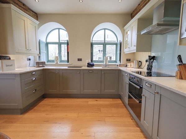 Enjoy cooking in this well-equipped kitchen with a central island, ample counter space, and integrated appliances.