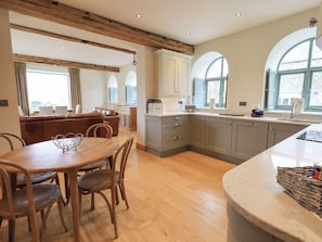 Enjoy meals and socialize in this kitchen with an oven, sink, and dining area.