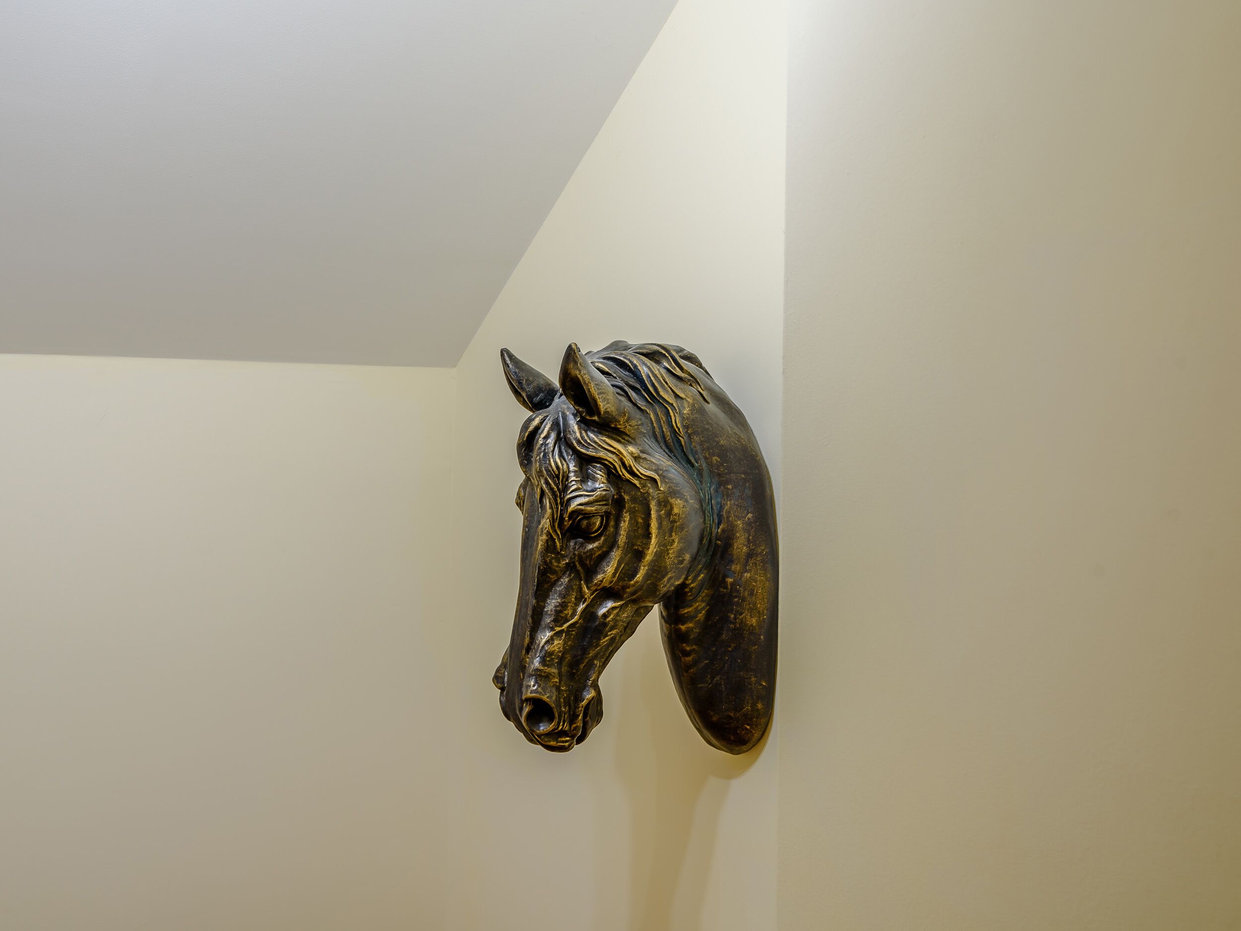 A wall-mounted sculpture of a horse head.