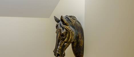 A wall-mounted sculpture of a horse head.