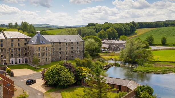 A large stone building with multiple windows and a courtyard. - Bay View (Belford)