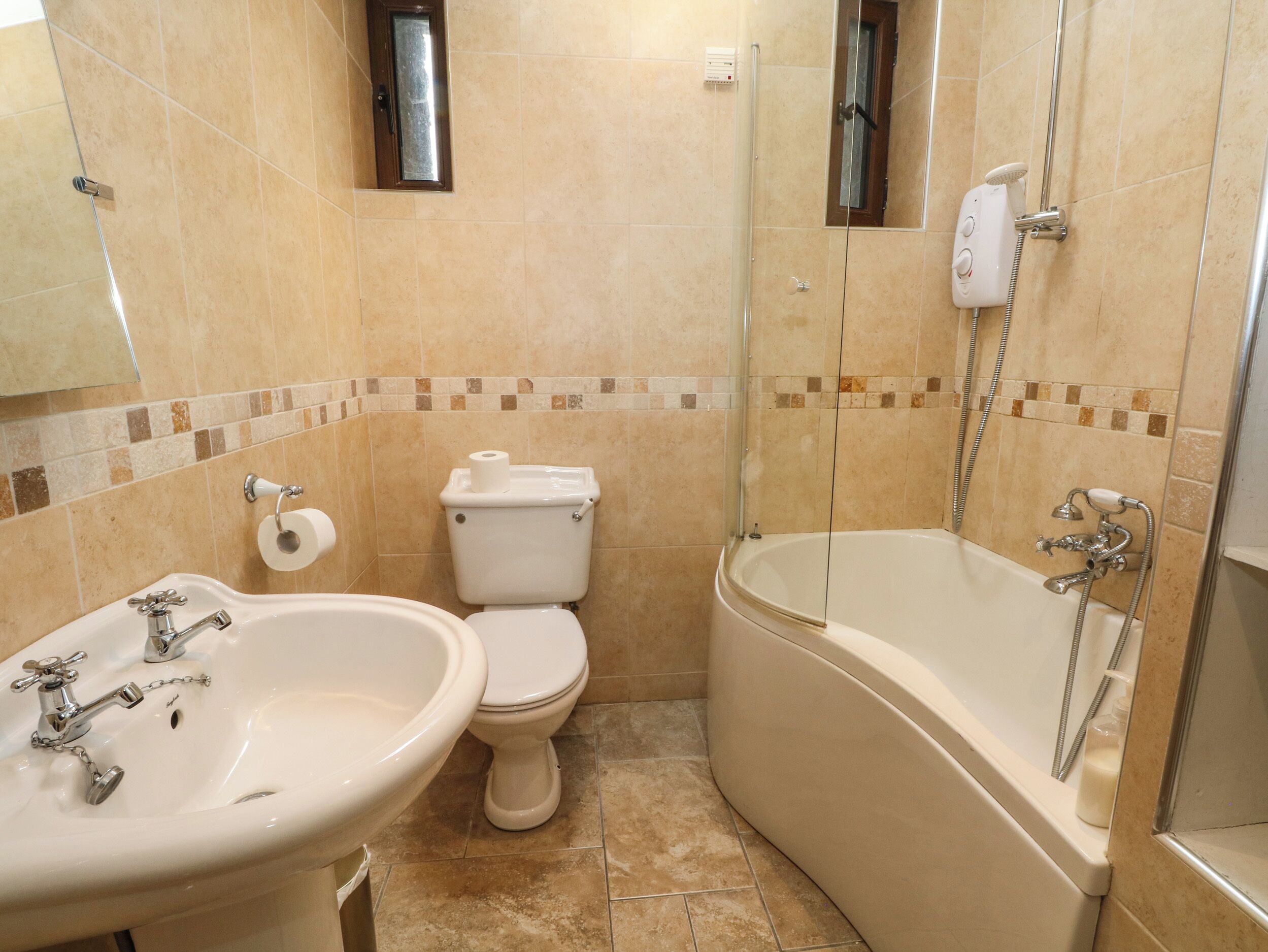 A bathroom with a sink, toilet, and bathtub.