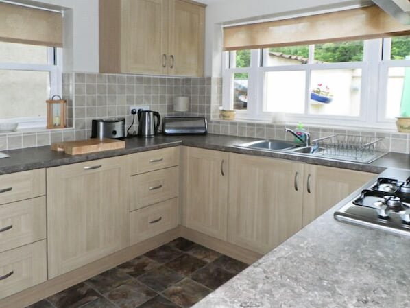 Enjoy cooking in this well-equipped kitchen with a gas stove, sink, and appliances.