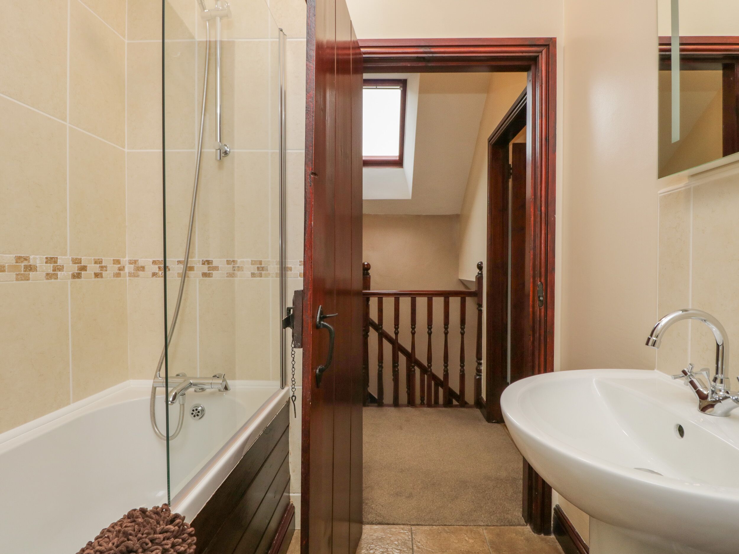 A bathroom with a bathtub, a shower, and a sink.