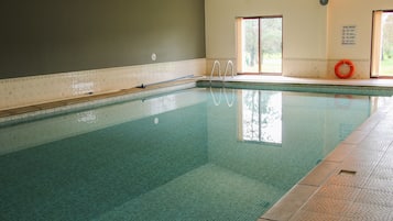Relax by the rectangular pool surrounded by a tiled deck and enjoy easy access with two ladders.