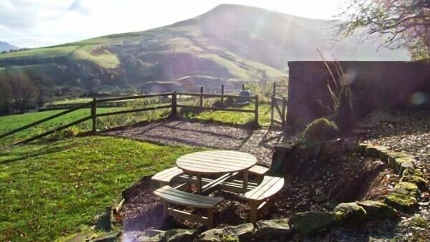 A picnic table set up outdoors with a mountain in the background. - The Stables (Hope Valley)