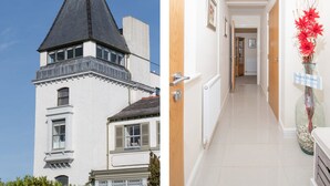 A two-story building with a steep roof and a balcony. - The Moorings (Conwy)