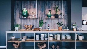 A modern interior with wooden shelves displaying various decorative items and a wine bottle.