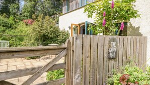 A wooden gate with a sign reading "The Garden Flat." - The Garden Flat (Fort William)
