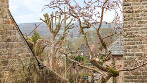 A stone building with a view of a tree and distant landscape. - Ash Cottage (Bakewell)