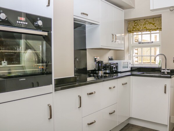 Enjoy cooking in this well-equipped kitchen with an oven, coffee maker, and toaster.