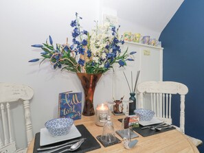 Enjoy meals for two at a beautifully set table with a stunning floral arrangement and elegant decor.