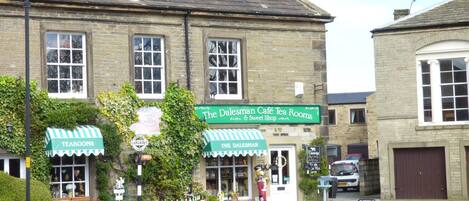 A traditional building with a green awning labeled 'The Dalesman Café Tea Rooms & Sweet Shop.'
