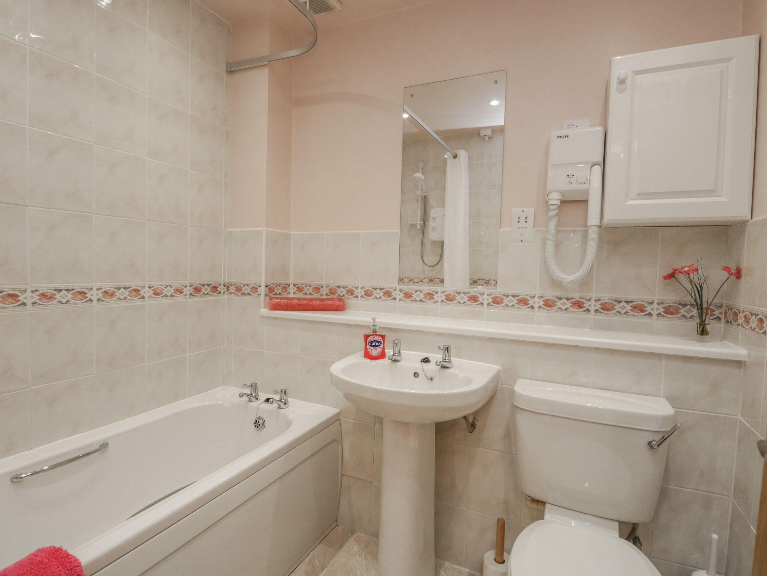 A bathroom with a bathtub, sink, and toilet.