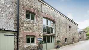 A stone building with a sign reading "Mill Barn." - Mill Barn (Kingsbridge)