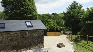 A stone building with a sloped roof and a skylight. - Torrings Barn (Kingsbridge)