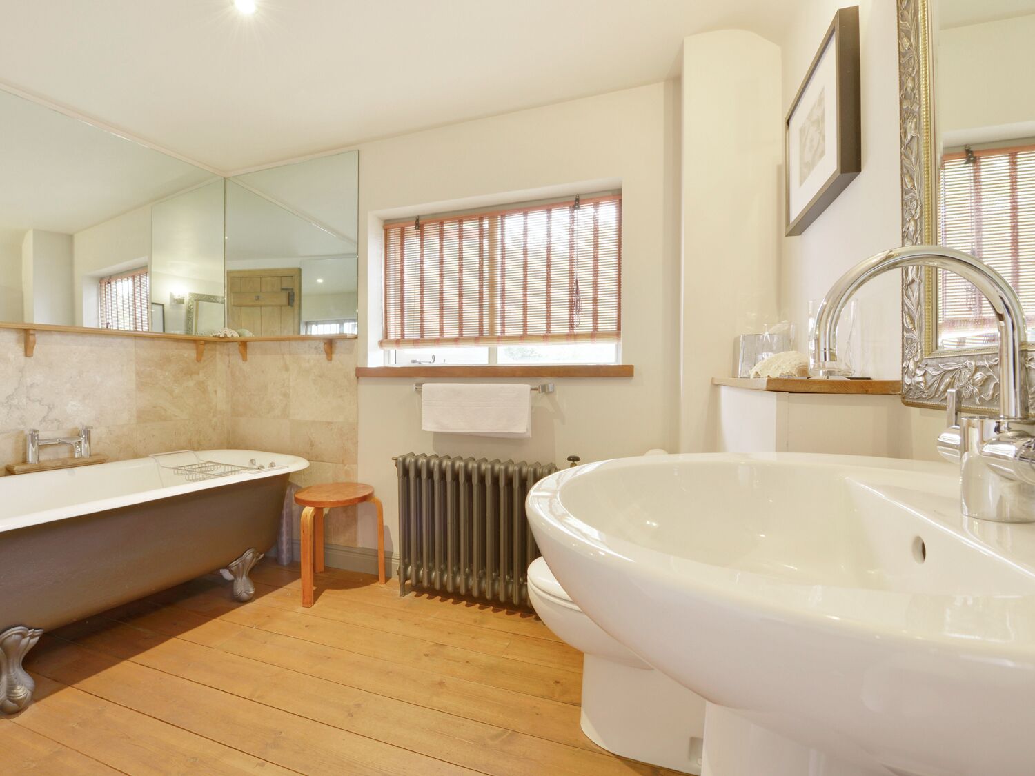 A bathroom with a freestanding bathtub, a sink, and a toilet.