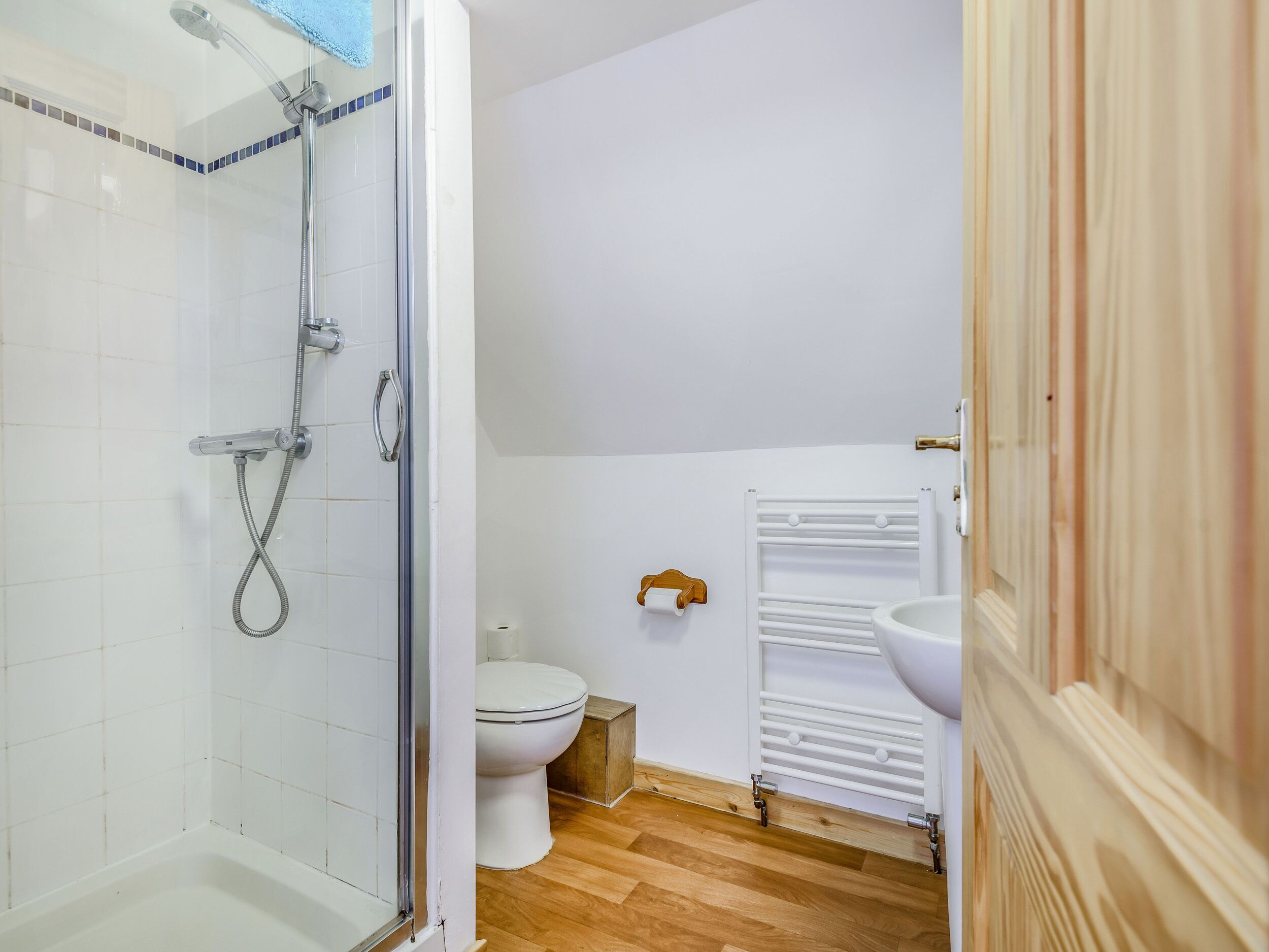 A bathroom with a shower, toilet, and sink.