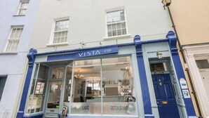 A cafe named "Vista at Tenby" with a clear glass front, a signboard, and a blue door. - Apartment 2 (Tenby)