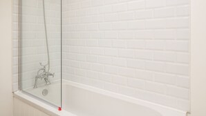 A glass-enclosed shower with a handheld showerhead and a handheld faucet. - Granary 2 (Hereford)