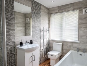 A modern bathroom with a white sink, toilet, and bathtub. - Little Retreat (Liskeard)