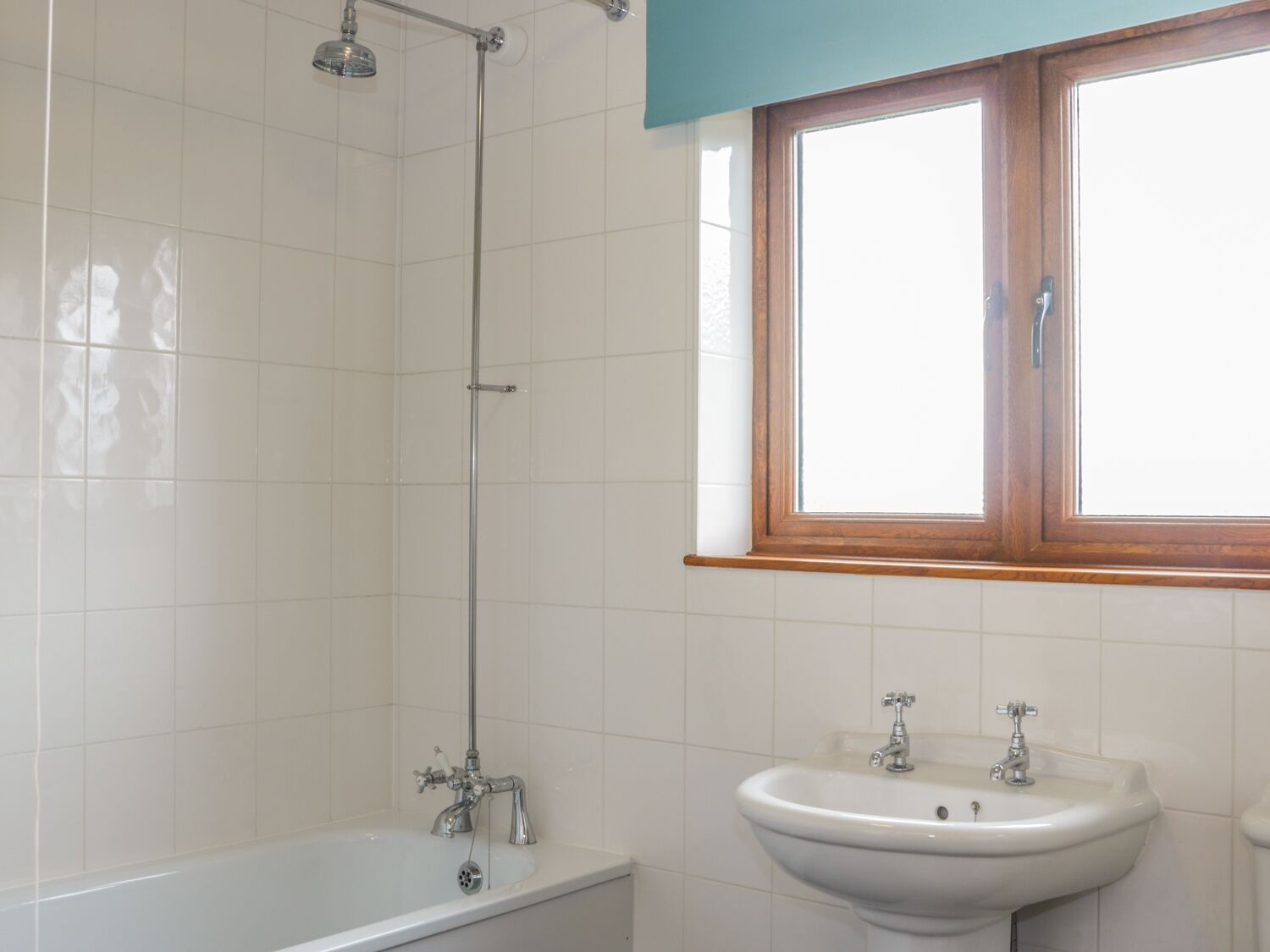 A bathroom with a bathtub, a sink, and a shower.