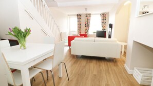 A modern apartment with a dining area, a living room, and a staircase. - Glan Y Don (Y Felinheli)