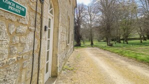 A stone building with a sign reading "COACH HOUSE PRIVATE."