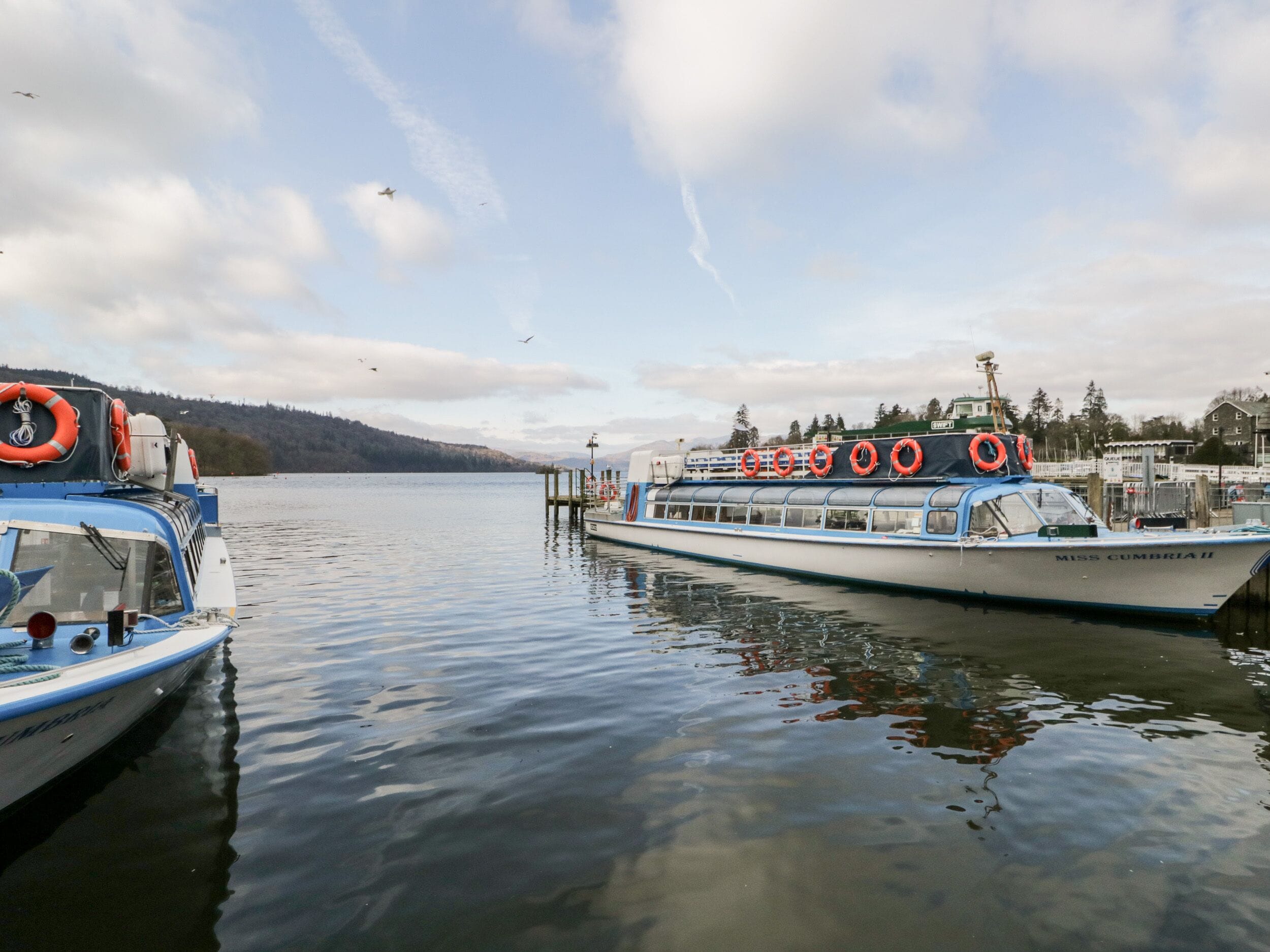 A docked boat with lifebuoys and a cabin.